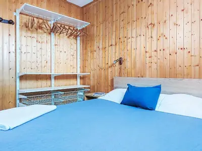 a bedroom with a bed and a wooden wall at Apartment Topaze-2 by Interhome in Saint-Gervais-les-Bains