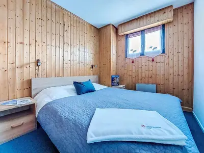 a stuffed animal with long horns sitting on a bed at Apartment Topaze-2 by Interhome in Saint-Gervais-les-Bains