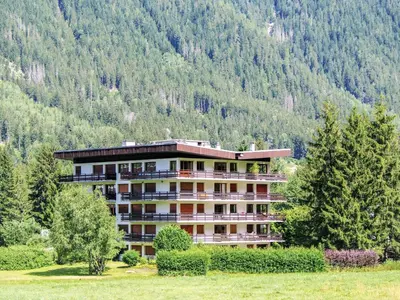 a tall building with snow in front of it at Apartment Le Bois du Bouchet-8 by Interhome in Chamonix-Mont-Blanc