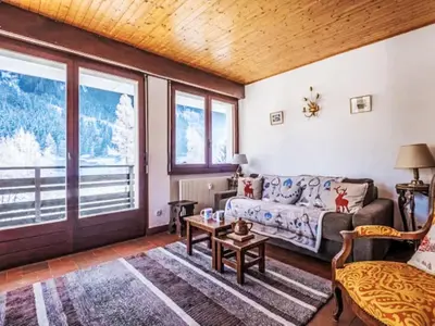 a living room with a couch and a table at Apartment Le Bois du Bouchet-8 by Interhome in Chamonix-Mont-Blanc