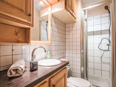 a kitchen with wooden cabinets and a sink and a dishwasher at Apartment Le Bois du Bouchet-8 by Interhome in Chamonix-Mont-Blanc