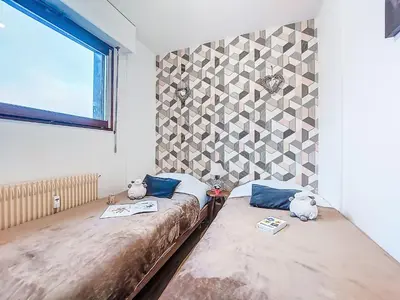 two beds in a room with two stuffed animals on them at Apartment Le Diorama-4 by Interhome in Saint-Gervais-les-Bains