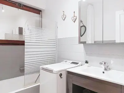 a white bathroom with a sink and a mirror at Apartment Le Diorama-4 by Interhome in Saint-Gervais-les-Bains