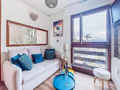 a living room with a table with wine glasses on it at Apartment Le Diorama-4 by Interhome in Saint-Gervais-les-Bains