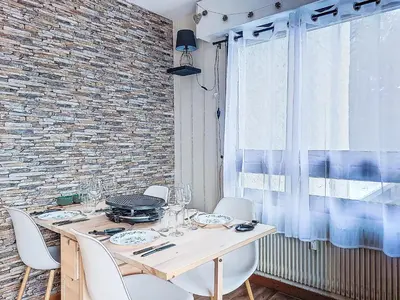 a living room with a couch and a kitchen at Apartment Le Diorama-4 by Interhome in Saint-Gervais-les-Bains