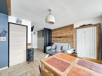 a bedroom with a bed and a couch at PLA233 - Studio neuf 4 pers centre village in Les Carroz d'Araches