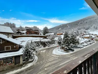 a town with snow covered buildings and a street at PLA233 - Studio neuf 4 pers centre village in Les Carroz d'Araches