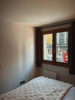 a bedroom with a bed and a window at Soleil in Chamonix-Mont-Blanc