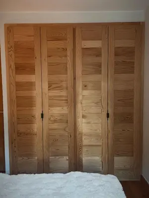 a wooden closet in a bedroom with a bed at Soleil in Chamonix-Mont-Blanc