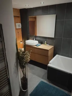 a bathroom with a sink and a toilet and a mirror at Soleil in Chamonix-Mont-Blanc