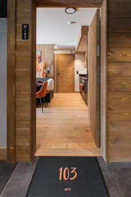 a hallway leading to a kitchen with a dining room at Veriaz - Appart 1 CH Cocon Design Confort in Megève
