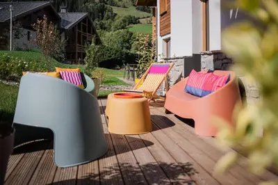 a group of chairs sitting on a deck at Veriaz - Appart 1 CH Cocon Design Confort in Megève