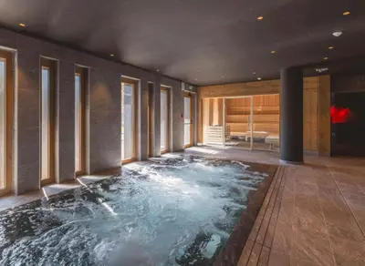 a bathtub in the middle of a room with water at Veriaz - Appart 1 CH Cocon Design Confort in Megève