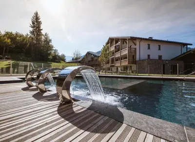 a water feature next to a swimming pool at Veriaz - Appart 1 CH Cocon Design Confort in Megève