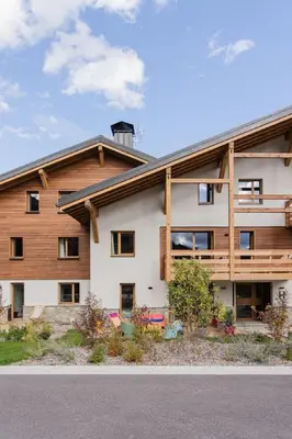 a white building with a wood at Veriaz - Appart 1 CH Cocon Design Confort in Megève
