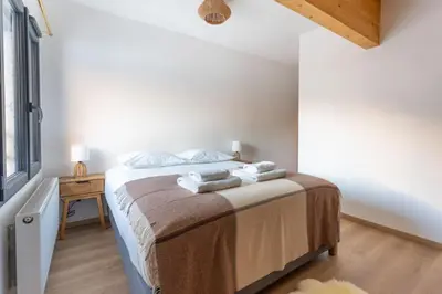a bedroom with a bed with towels on it at Babotches - Chalet 110m2 Moderne Familial 7 pax in Chamonix-Mont-Blanc