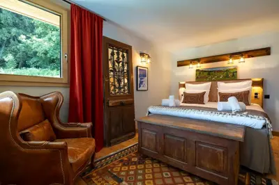 a living room with a couch and a large window at Repos du Loup - Chalet 4CH 4SDB Jacuzzi BainNordique in Chamonix-Mont-Blanc