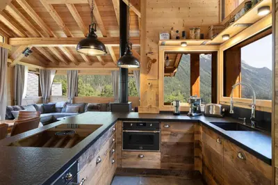 a group of wooden homes on a road at Repos du Loup - Chalet 4CH 4SDB Jacuzzi BainNordique in Chamonix-Mont-Blanc