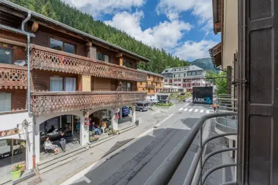 an empty street in a mountain town with buildings at Straton - Cosy 1 CH Modern Hypercentre Transport 150m in Chamonix-Mont-Blanc