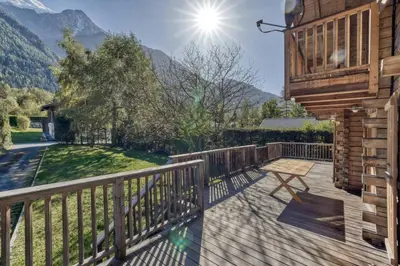 a wooden deck with a bench on the side of a house at Clairtemps- Charmant Chalet 168 m2 6 Pax Familial Vue in Les Houches