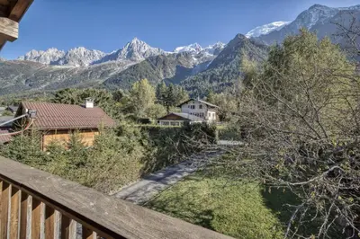 a view from the balcony of a house in the mountains at Clairtemps- Charmant Chalet 168 m2 6 Pax Familial Vue in Les Houches