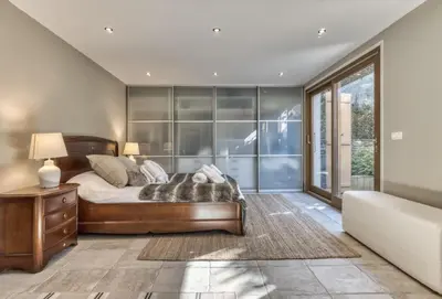 a bedroom with a bed and a large window at Clairtemps- Charmant Chalet 168 m2 6 Pax Familial Vue in Les Houches