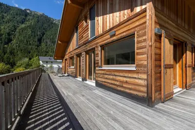 a wooden deck on the side of a house at Les Iles - Chalet 165m2 Vue Mont Familial 10 pax in Chamonix-Mont-Blanc