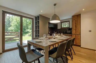 a dining room with a large table and chairs at Modern Luxury Chalet BADI with Sauna - Happy Rentals in Chamonix-Mont-Blanc