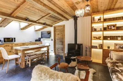 a living room with a table and a fireplace at Cozy 2BDR-5P apartment near the ski slopes in Megève