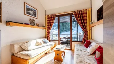a living room with a couch and a window at Grand Morillon N404 2P6 Mezzanine in Morillon