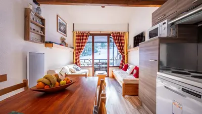 a living room with a bowl of fruit on a table at Grand Morillon N404 2P6 Mezzanine in Morillon