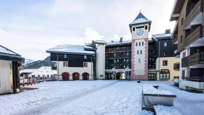 a building with a clock tower in the snow at Grand Morillon N404 2P6 Mezzanine in Morillon