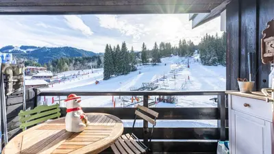 a room with a table with a view of a ski slope at Grand Morillon N404 2P6 Mezzanine in Morillon