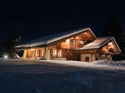 a log cabin in the snow at night at Chalet Grand Standing à Megève - 5 min des Pistes, 5 Chambres, 10 Pers. - FR-1-432-95 in Megève