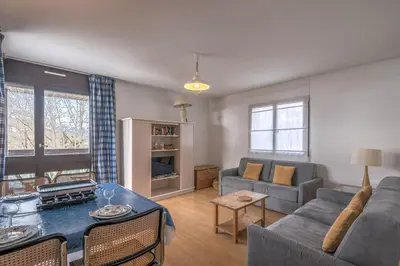 a living room with a couch and a table at Appartement L'Écrin du Mont d'Arbois - Welkeys in Saint-Gervais-les-Bains