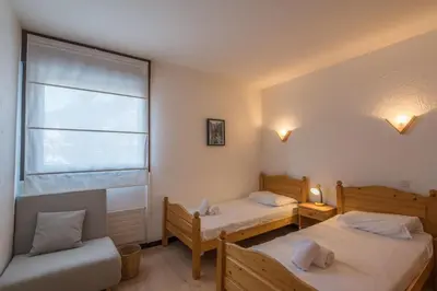 a bedroom with two beds and a window at Appartement L'Écrin du Mont d'Arbois - Welkeys in Saint-Gervais-les-Bains
