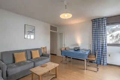 a living room with a couch and a table at Appartement L'Écrin du Mont d'Arbois - Welkeys in Saint-Gervais-les-Bains