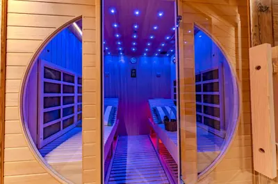 a room with a hallway with blue and purple lights at Luxurious Chalet with Sauna & Jacuzzi in Megeve with Parking in Megève