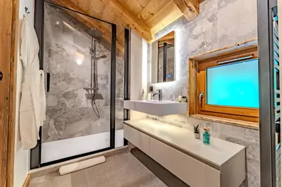 a bathroom with a tub and a sink and a shower at Luxurious Chalet with Sauna & Jacuzzi in Megeve with Parking in Megève