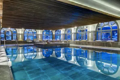 a swimming pool in a building with windows at Beautiful apartment in 5 stars residence with pool in Chamonix-Mont-Blanc