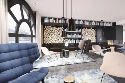 a living room with a blue couch and chairs at Beautiful apartment in 5 stars residence with pool in Chamonix-Mont-Blanc