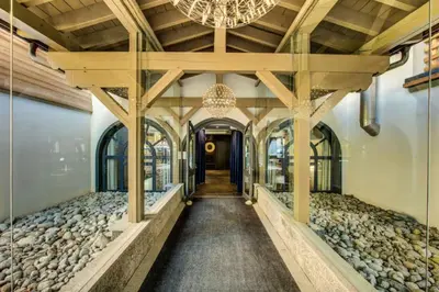 a hallway in a building with a chandelier at Beautiful apartment in 5 stars residence with pool in Chamonix-Mont-Blanc