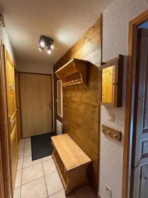 a kitchen with a wooden bench in a room at LES BEULETTES b in Samoëns