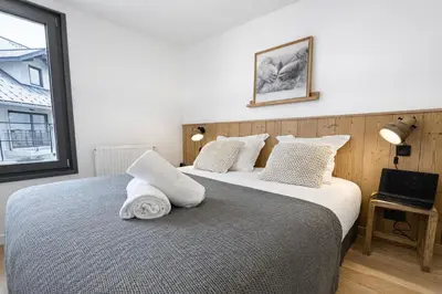 a bedroom with a large bed with white pillows at Les Sources de Canopee - Calme, Vue & Ski in Saint-Gervais-les-Bains