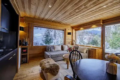 a small living room with a table and a couch at Appartement Le Pacha - Proche Centre Ville in Megève