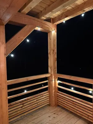 a screened in porch with wood panels and lights at Contamines Montjoie appartement 2 chambres et cabine in Les Contamines-Montjoie