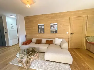 a living room with a couch and a table at Contamines Montjoie appartement 2 chambres et cabine in Les Contamines-Montjoie