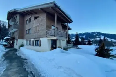a large building with snow in front of it at Stay at the heart of the slopes in Megève! in Megève