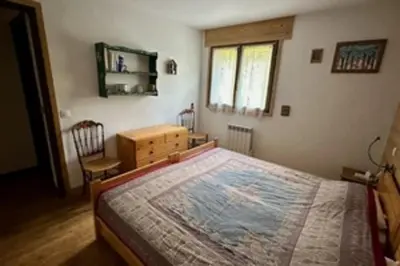 a bedroom with a bed and a desk and a window at Stay at the heart of the slopes in Megève! in Megève