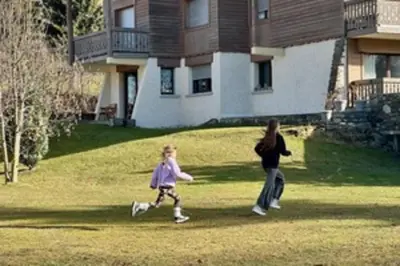 a woman and a child playing frisbee in a yard at Stay at the heart of the slopes in Megève! in Megève